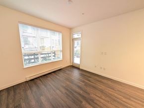 Surrey apartment for rent - A room with a window and a door is empty and waiting to be furnished.