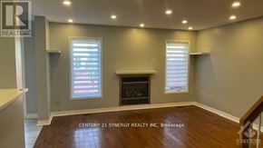 Ottawa townhouse for rent - A well-lit room with a fireplace and a window with blinds.