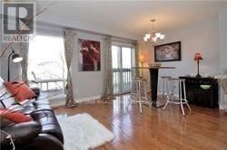 Mississauga (Central Erin Mills) townhouse for rent - A living room with a black leather couch and a white rug.