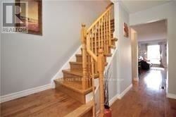 Mississauga (Central Erin Mills) townhouse for rent - A wooden staircase with a white wall on the side.