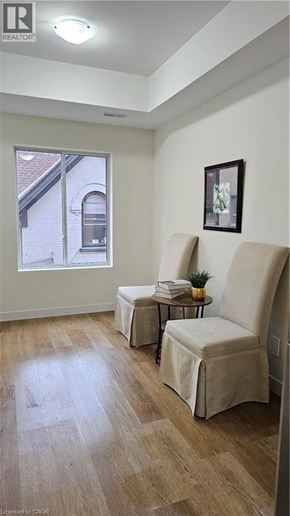 Kitchener apartment for rent - A room with two chairs and a table with a plant on it.