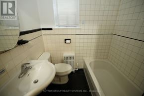 Toronto (Oakwood Village) multi-family for rent - A bathroom with a white sink, toilet, and bathtub.