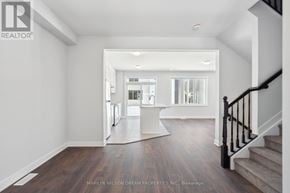 Ottawa townhouse for rent - A spacious hallway with a staircase leading to the second floor.
