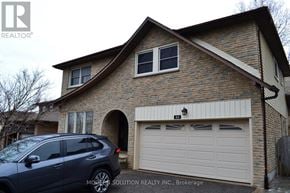 Newmarket (Gorham-College Manor) apartment for rent - A house with a garage and a car parked in front.