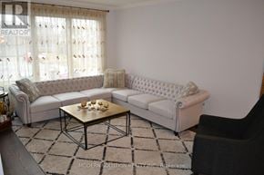 Newmarket (Gorham-College Manor) apartment for rent - A living room with a white couch and a coffee table.