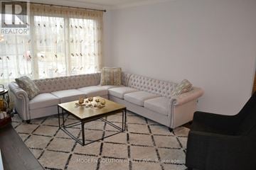 Newmarket (Gorham-College Manor) apartment for rent - A living room with a white couch and a coffee table.