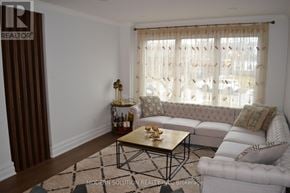 Newmarket (Gorham-College Manor) apartment for rent - A living room with a white couch and a coffee table.