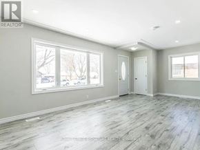 Kitchener apartment for rent - A spacious room with grey flooring and white walls.