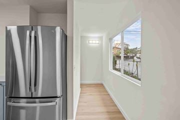 Kailua Kona apartment for rent - A modern kitchen with a stainless steel refrigerator and wooden flooring.