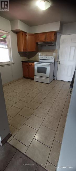 Windsor multi-family for rent - A kitchen with a white stove top oven and brown cabinets.