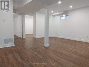 Richmond Hill (North Richvale) apartment for rent - A room with wooden floors and white walls.