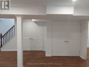 Richmond Hill (North Richvale) apartment for rent - A white interior with a staircase on the left and two doors in the center.