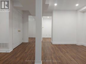 Richmond Hill (North Richvale) apartment for rent - A room with wooden floors and white walls.