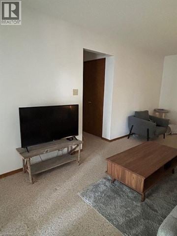 Listowel apartment for rent - A living room with a television and a couch.