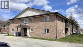 Listowel apartment for rent - A brick house with a car parked in front.