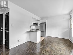 Toronto (Annex) condo for rent - A kitchen area with a refrigerator, microwave, and oven.