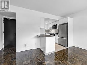 Toronto (Annex) condo for rent - A kitchen with a refrigerator, microwave, and oven.