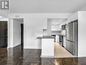 Toronto (Annex) condo for rent - A kitchen with a white fridge and stove top oven.