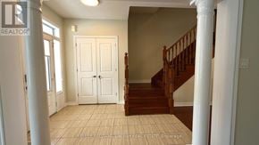 Markham (Cornell) apartment for rent - A white door with a black handle is in a room with a wooden staircase.
