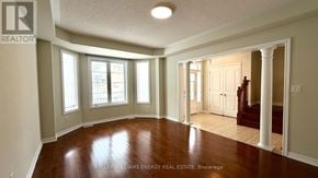 Markham (Cornell) apartment for rent - A spacious room with wooden floors and white walls.