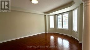 Markham (Cornell) apartment for rent - A room with wooden floors and a window with a view of a building outside.