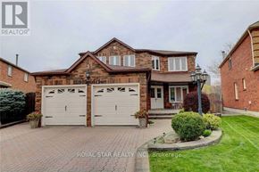 Mississauga (Hurontario) apartment for rent - A house with a brick facade and a white garage door is for sale.
