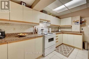 Mississauga (Hurontario) apartment for rent - A kitchen with a white stove and cabinets.