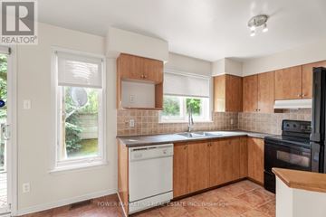 Ottawa condo for rent - A kitchen with wooden cabinets and a black oven.