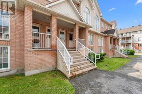 Ottawa condo for rent - A red brick house with a white railing and stairs leading to the front door.
