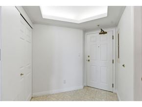 Surrey apartment for rent - A white door with a gold handle is in a room with white walls.