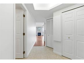 Surrey apartment for rent - A hallway with white doors and a tiled floor.