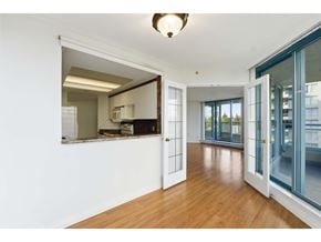 Surrey apartment for rent - A room with a white wall and a wooden floor.