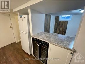Ottawa triplex for rent - A kitchen with a white fridge and a granite counter top.