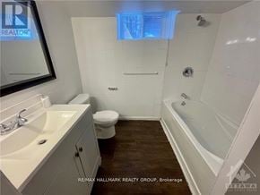 Ottawa triplex for rent - A white bathroom with a toilet, sink, and bathtub.