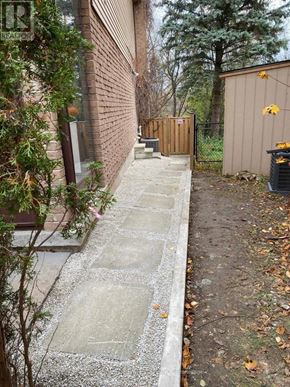 Richmond Hill (North Richvale) apartment for rent - A concrete pathway leads from a building to a wooden structure.