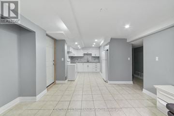 Brampton (Westgate) apartment for rent - A spacious kitchen with white cabinets and appliances.