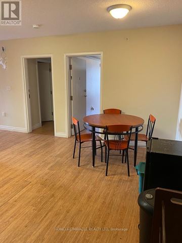 Waterloo condo for rent - A dining room with a wooden table and chairs.