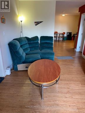 Waterloo condo for rent - A blue couch with a wooden coffee table in front of it.