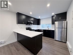 Hamilton apartment for rent - A modern kitchen with black cabinets and a white countertop.
