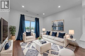 Kitchener condo for rent - A living room with a white sofa, a coffee table, and a painting on the wall.