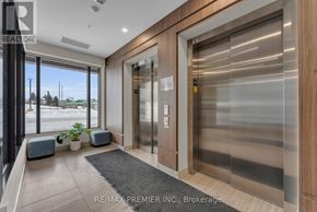 Kitchener condo for rent - A modern office lobby with a glass wall and a wooden door.