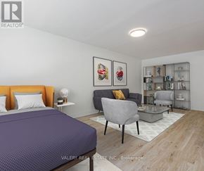 Toronto (Danforth Village-East York) condo for rent - A bedroom with a bed, chair, and shelves.