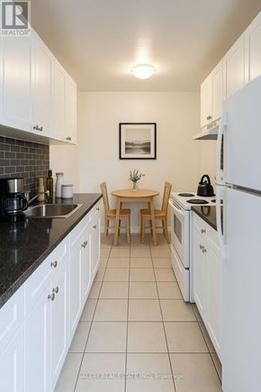 Toronto (Woburn) condo for rent - A modern living room with a dining table and a couch.