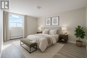 Toronto (Woburn) condo for rent - A bedroom with a large bed, a bench, and a potted plant.