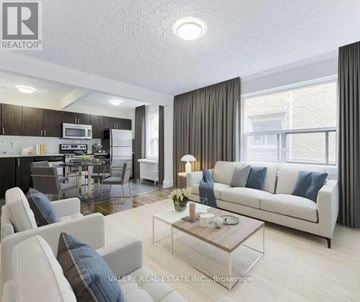 Toronto (Birchcliffe-Cliffside) condo for rent - A modern living room with a white sofa and a glass coffee table.