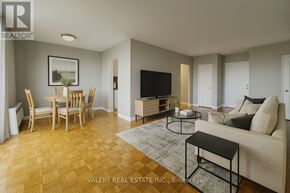Toronto (Woburn) condo for rent - A living room with a couch, chairs, and a television.