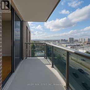 Toronto (Woburn) condo for rent - A balcony with a glass railing overlooking a cityscape.