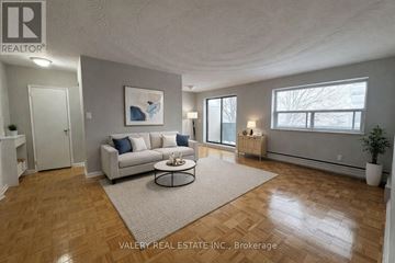 Toronto (Wexford-Maryvale) condo for rent - A living room with a couch, a coffee table, and a painting on the wall.
