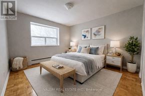 Toronto (Wexford-Maryvale) condo for rent - A bedroom with a bed, nightstands, and a plant.