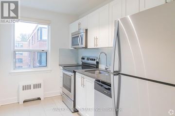 Toronto (Birchcliffe-Cliffside) condo for rent - A kitchen with white cabinets and a stainless steel refrigerator.